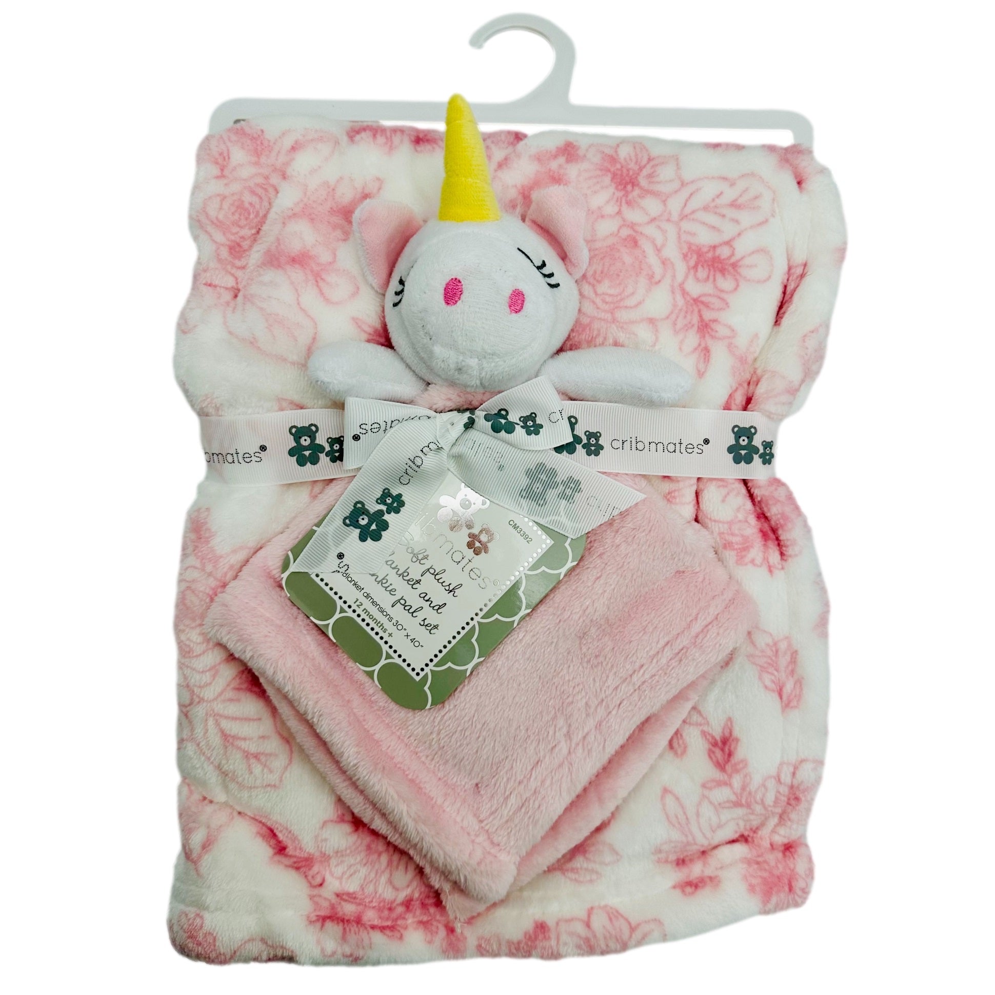 Folded plush baby blanket and lovie set with a white unicorn attached to a pink floral blanket, packaged on a hanger.